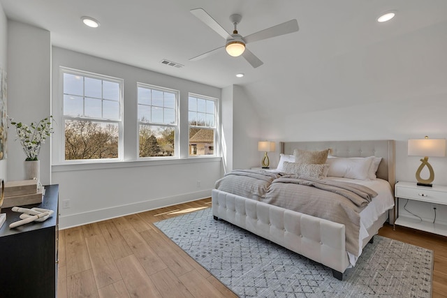 bedroom featuring lofted ceiling, ceiling fan, and light wood-type flooring