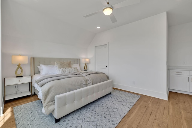 bedroom featuring vaulted ceiling, light wood-type flooring, and ceiling fan