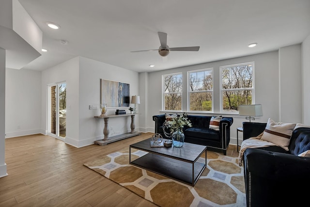 living room with ceiling fan and light hardwood / wood-style floors