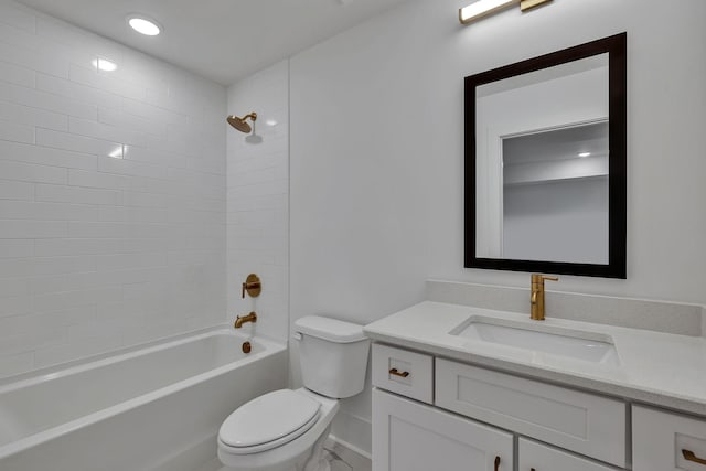 full bathroom featuring tiled shower / bath, vanity, and toilet