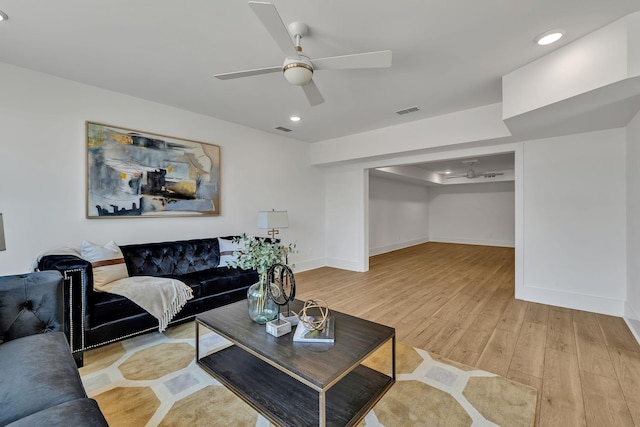 living room with ceiling fan and light wood-type flooring