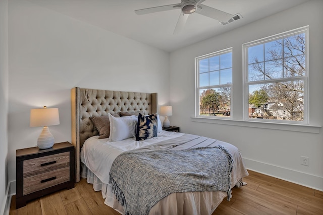 bedroom with ceiling fan and light wood-type flooring