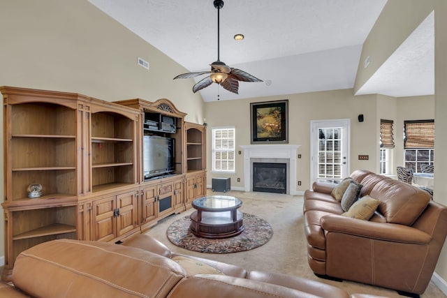 carpeted living room with ceiling fan and lofted ceiling