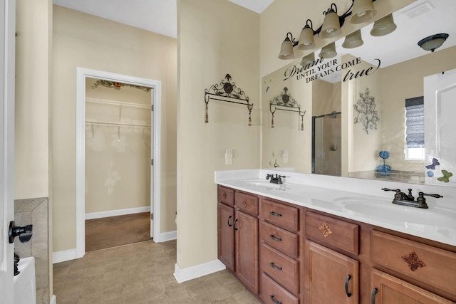 bathroom with vanity and a shower with shower door