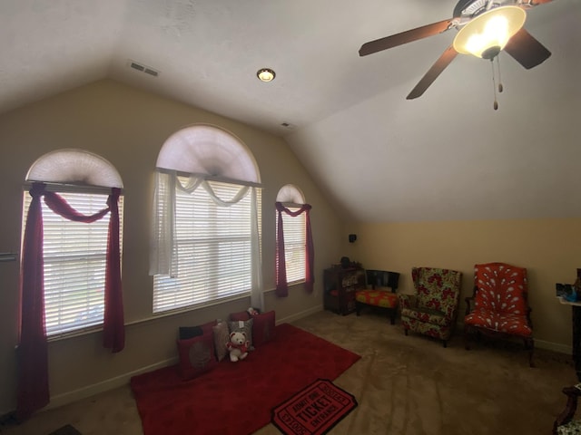 interior space with carpet, vaulted ceiling, and ceiling fan