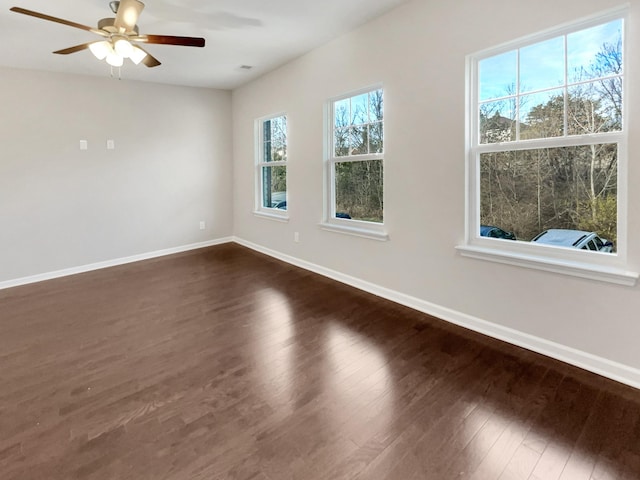 unfurnished room with ceiling fan and dark hardwood / wood-style flooring