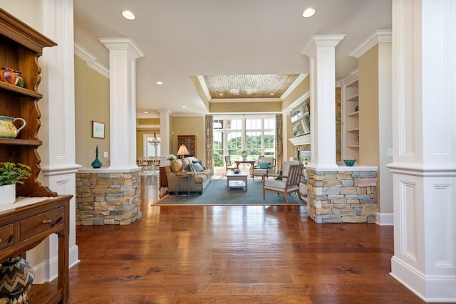 interior space with dark wood-type flooring, decorative columns, and crown molding