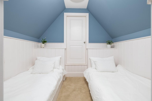 carpeted bedroom featuring lofted ceiling