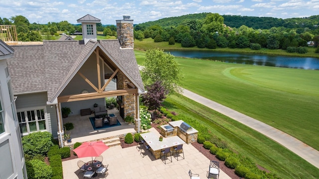 back of house with a patio area and a water view