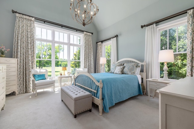 bedroom with an inviting chandelier, light colored carpet, multiple windows, and vaulted ceiling