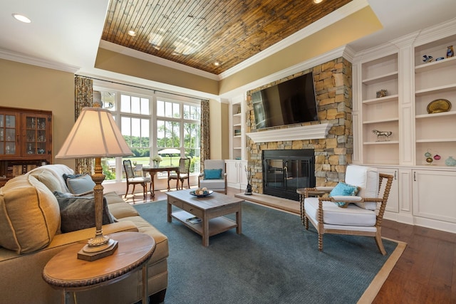 living room with built in shelves, wooden ceiling, dark hardwood / wood-style flooring, crown molding, and a fireplace