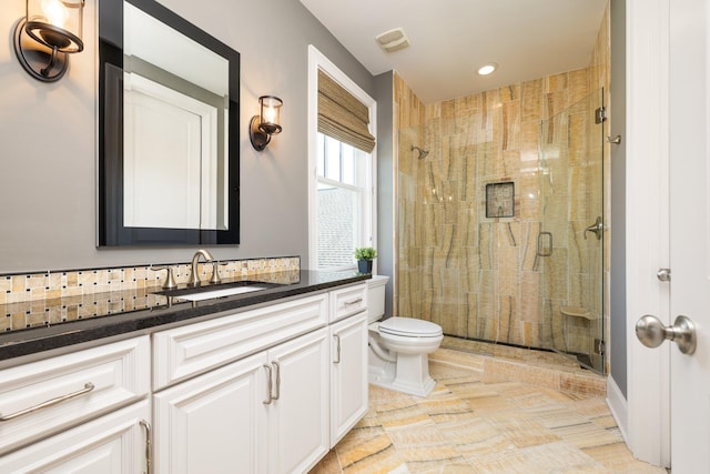 bathroom with vanity, toilet, and walk in shower