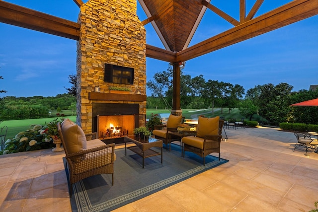 view of patio featuring an outdoor living space with a fireplace