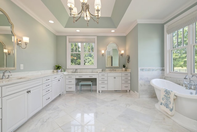 bathroom featuring a tray ceiling, plenty of natural light, a bathtub, and ornamental molding