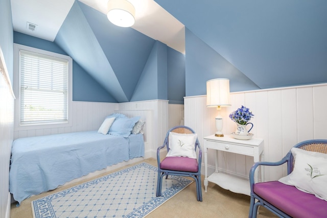 bedroom featuring multiple windows and lofted ceiling