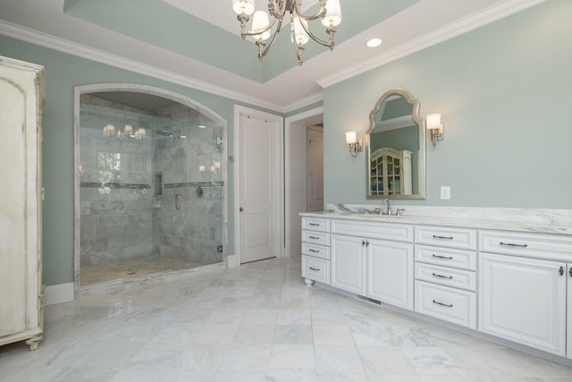 bathroom featuring a chandelier, vanity, a shower with door, and crown molding