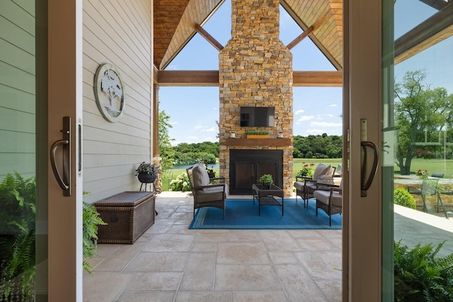 view of patio with an outdoor living space with a fireplace