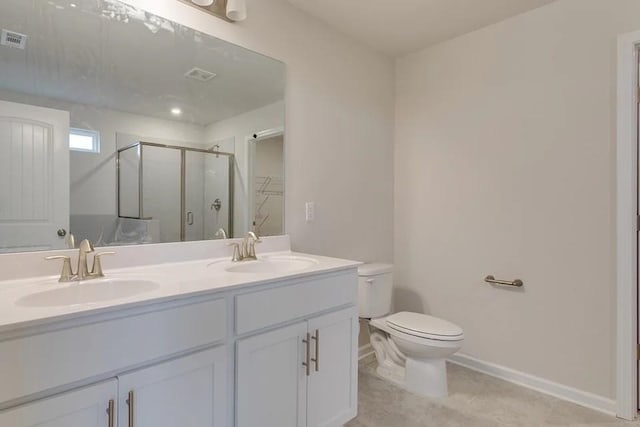 bathroom featuring tile patterned flooring, vanity, toilet, and a shower with door