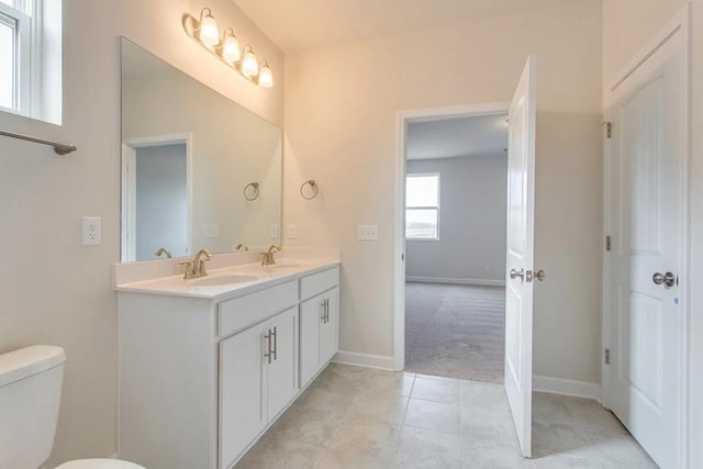 bathroom featuring tile patterned floors, vanity, and toilet