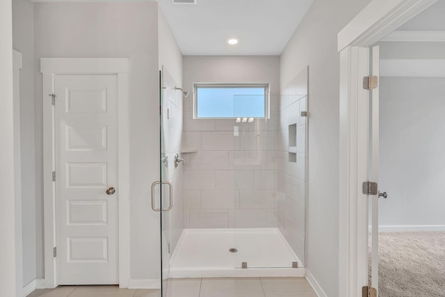 bathroom with tile patterned flooring and walk in shower