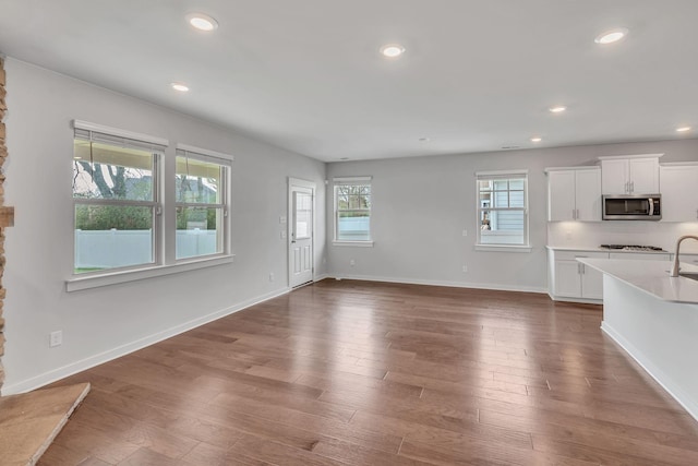 unfurnished living room with dark hardwood / wood-style floors