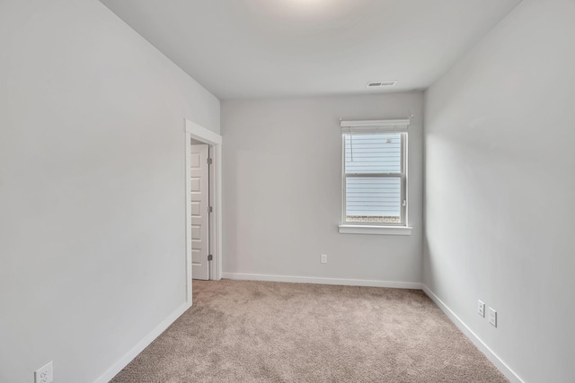 empty room featuring light colored carpet