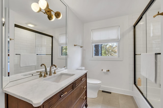 full bathroom with tile patterned flooring, vanity, toilet, and enclosed tub / shower combo