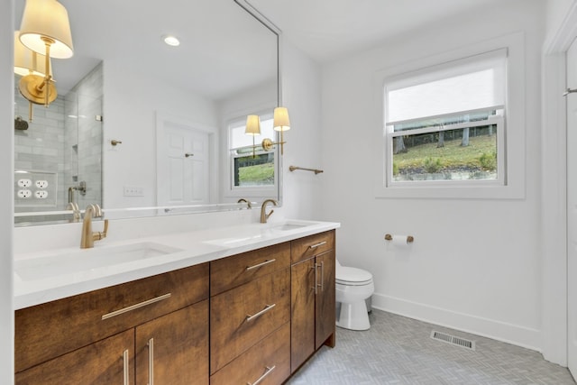 bathroom featuring tile patterned floors, vanity, an enclosed shower, and toilet