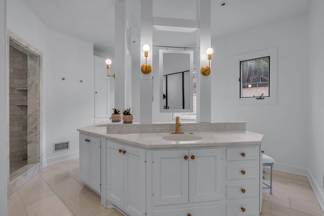 bathroom featuring tile patterned floors, vanity, a shower, and decorative backsplash