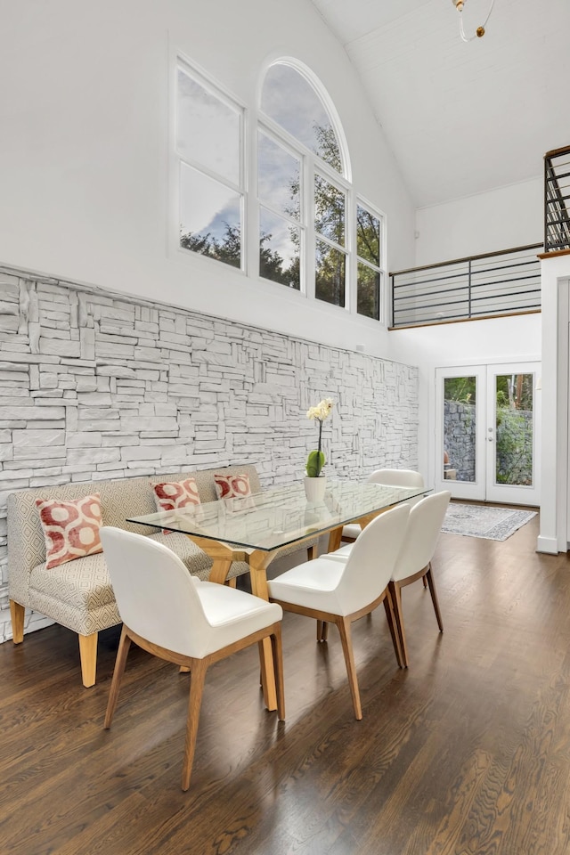 dining area featuring dark hardwood / wood-style flooring, breakfast area, high vaulted ceiling, and french doors