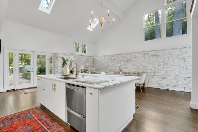 kitchen with a kitchen island with sink, sink, white cabinets, and high vaulted ceiling