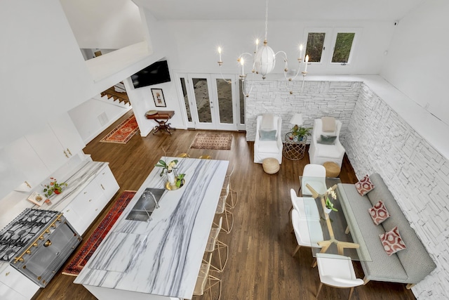 living room with french doors, dark wood-type flooring, and a chandelier