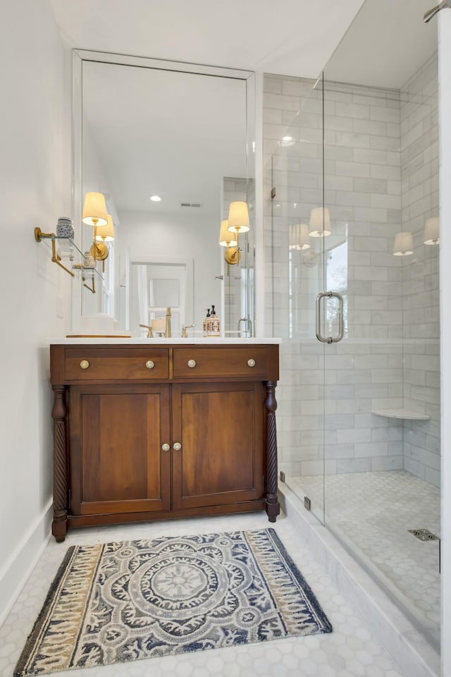 bathroom featuring vanity, tile patterned floors, and a shower with shower door