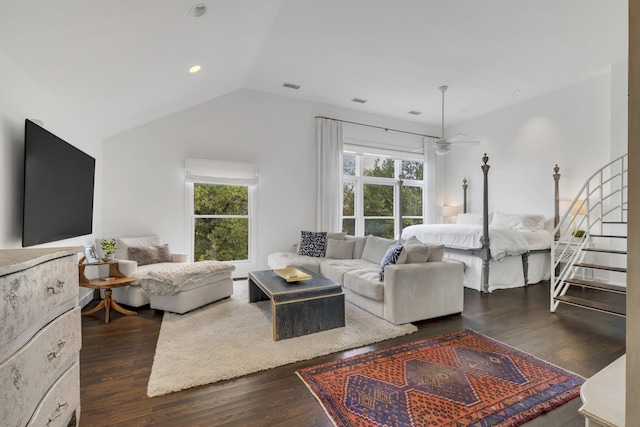 living room with a wealth of natural light, dark hardwood / wood-style floors, and ceiling fan