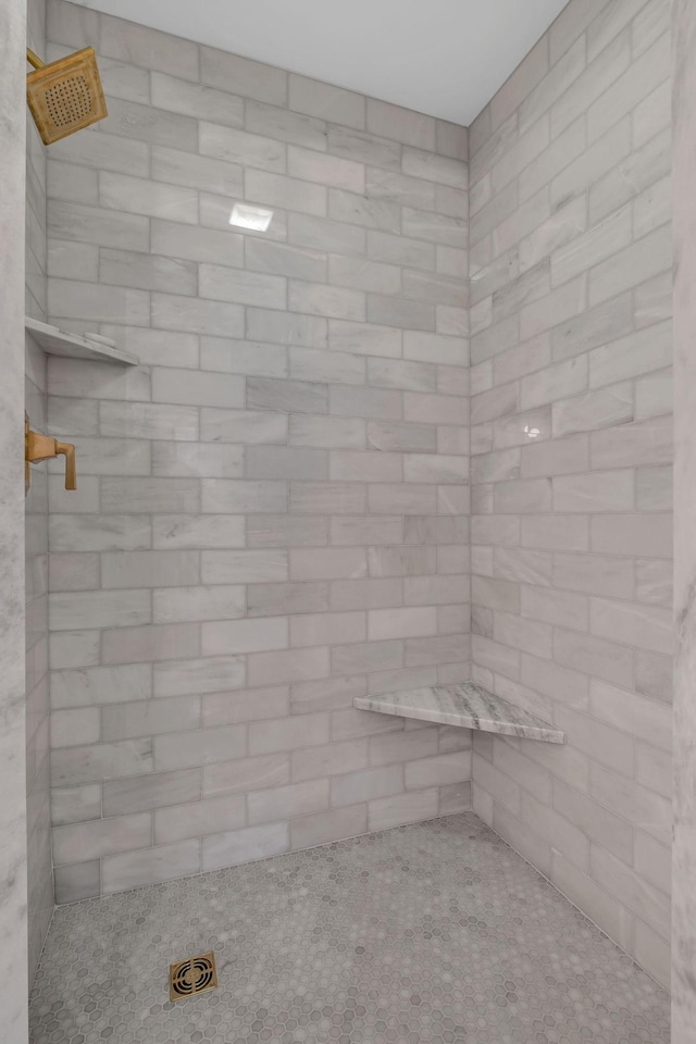 bathroom with a tile shower