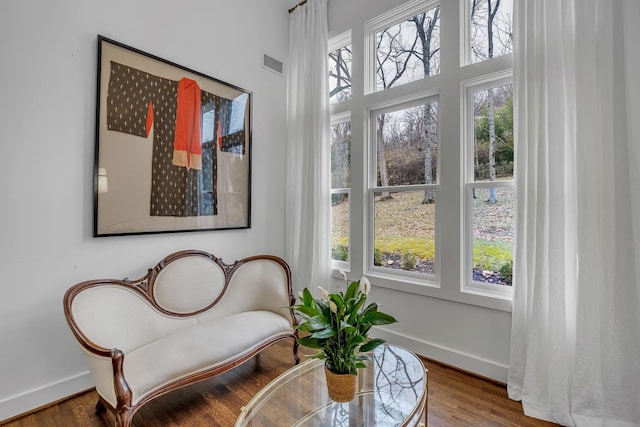 sitting room featuring hardwood / wood-style floors and a wealth of natural light