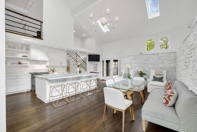 dining area with dark wood-type flooring, high vaulted ceiling, and a chandelier