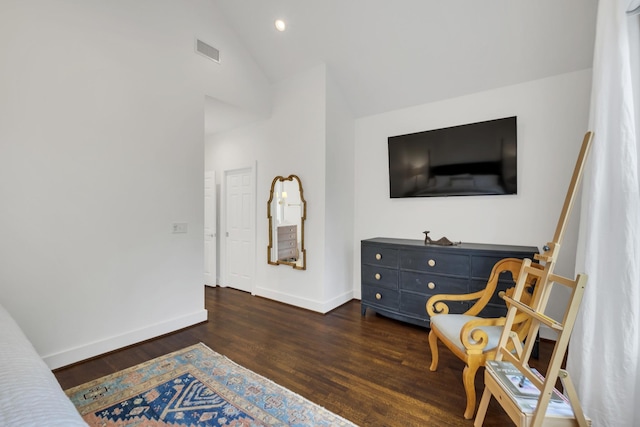 living area with dark hardwood / wood-style floors and lofted ceiling