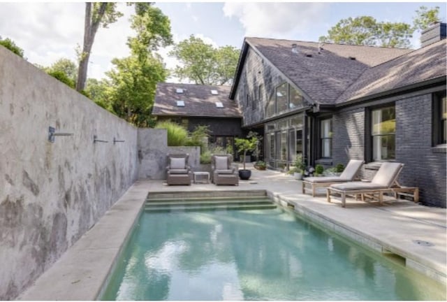 view of swimming pool with a patio area