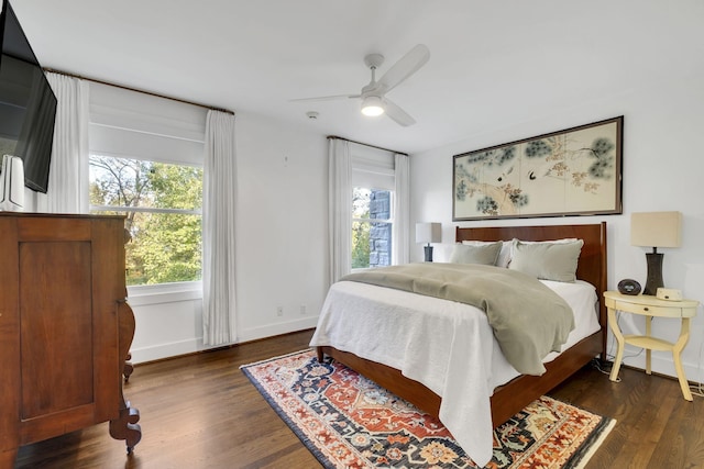 bedroom featuring ceiling fan and dark hardwood / wood-style flooring