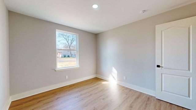 spare room with light hardwood / wood-style flooring