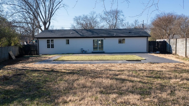 rear view of house with a yard