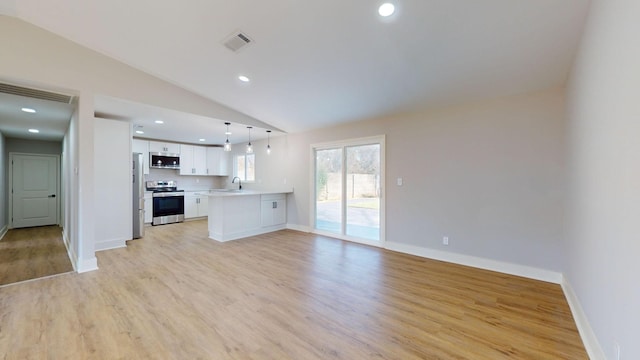 unfurnished living room with sink, light hardwood / wood-style floors, and vaulted ceiling