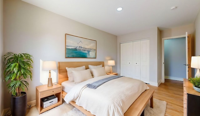 bedroom featuring light hardwood / wood-style flooring and a closet