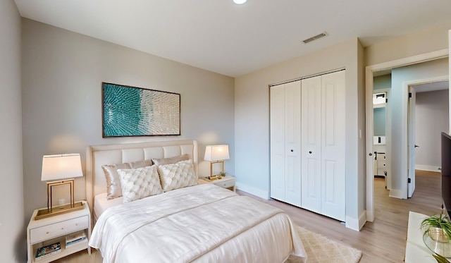 bedroom with light wood-type flooring and a closet