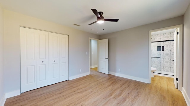 unfurnished bedroom with ceiling fan, light hardwood / wood-style flooring, ensuite bathroom, and a closet