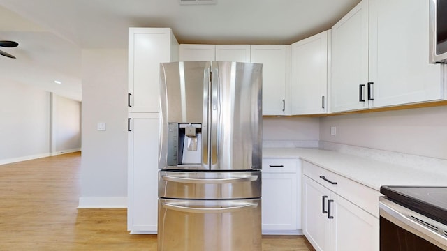 kitchen featuring stainless steel refrigerator with ice dispenser, light hardwood / wood-style flooring, and white cabinetry