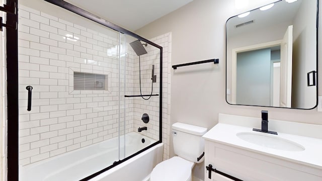 full bathroom featuring vanity, enclosed tub / shower combo, and toilet