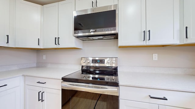 kitchen with white cabinets and appliances with stainless steel finishes