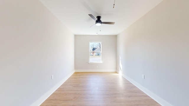 unfurnished room with ceiling fan and light wood-type flooring